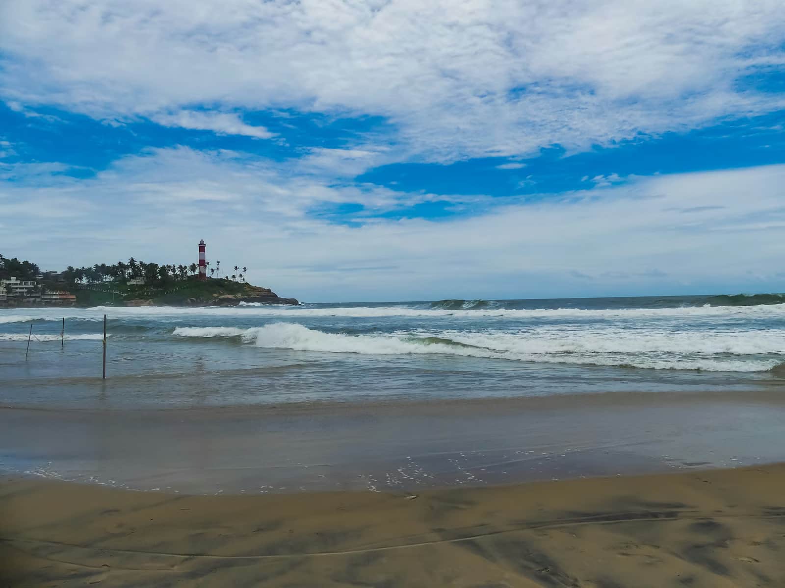 Kovalam Lighthouse Beach at dusk, the iconic crescent bay of South Kerala