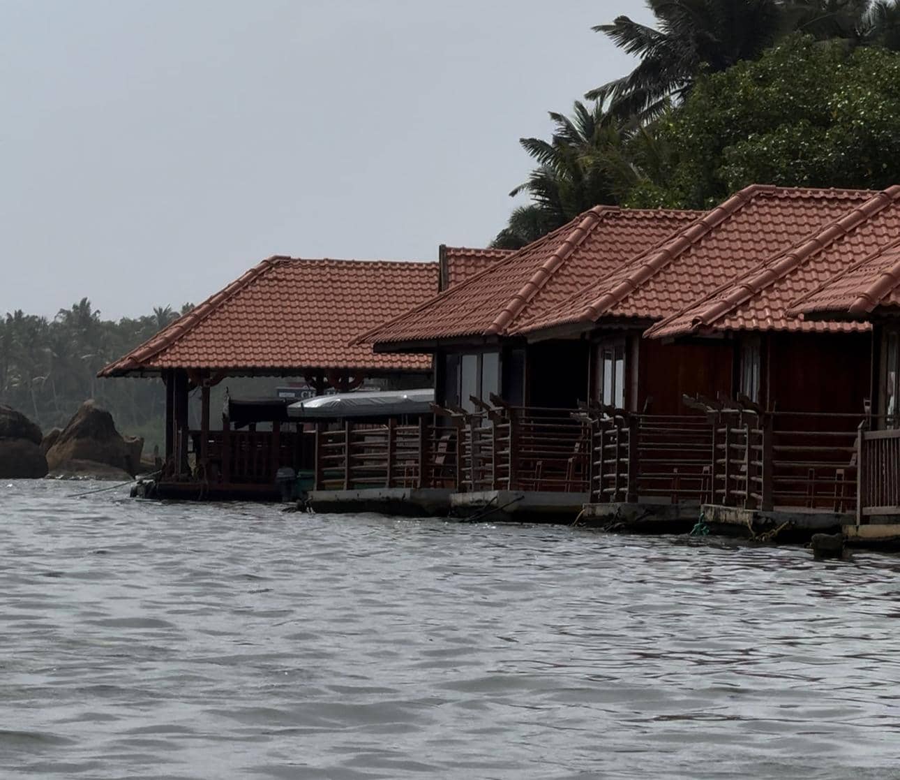 The lagoon opens up — brackish water, fishing boats, the first view of Poovar Island