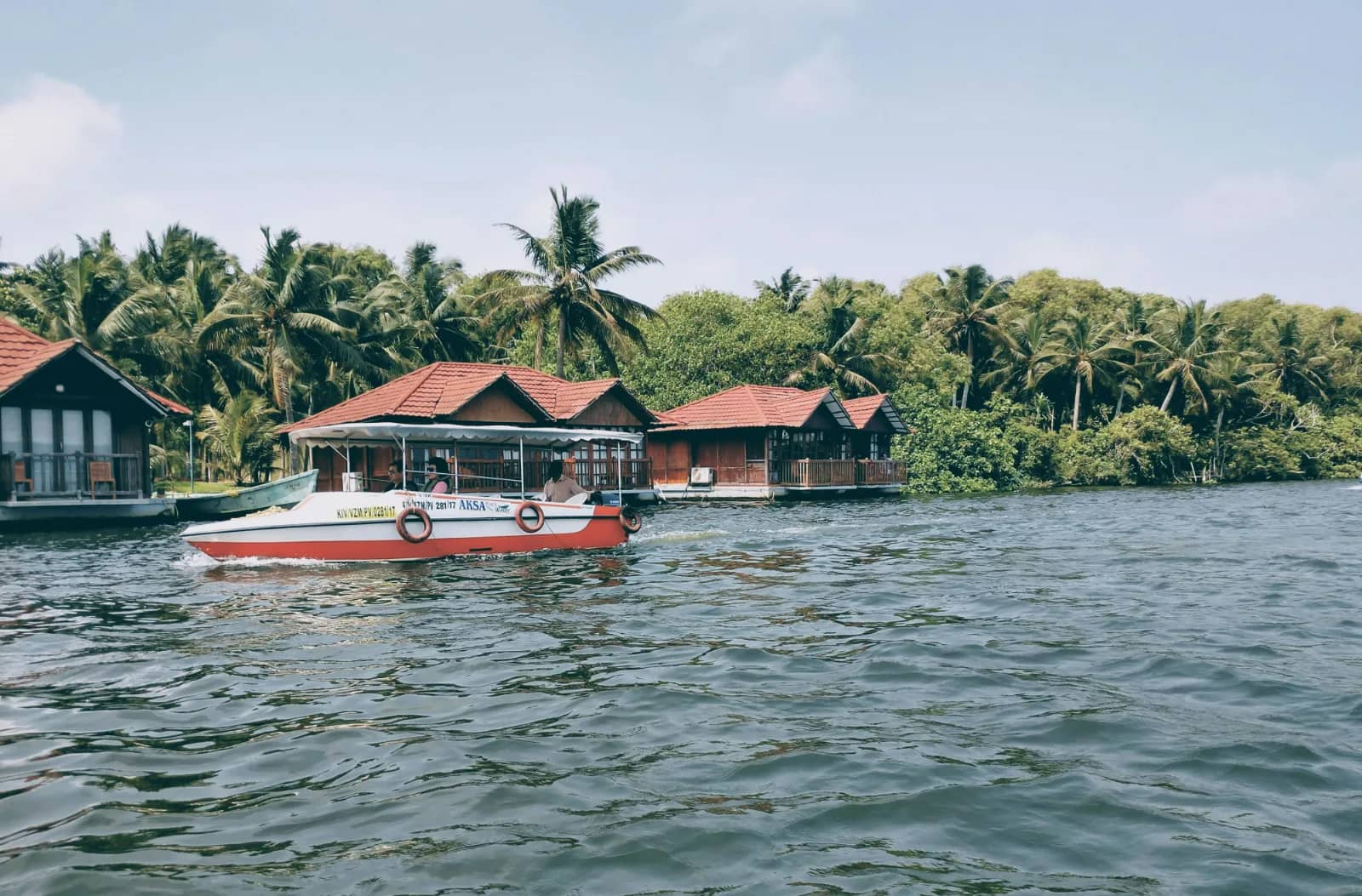 Poovar Island boating experience through the backwaters with boats, mangroves, and scenic estuary views