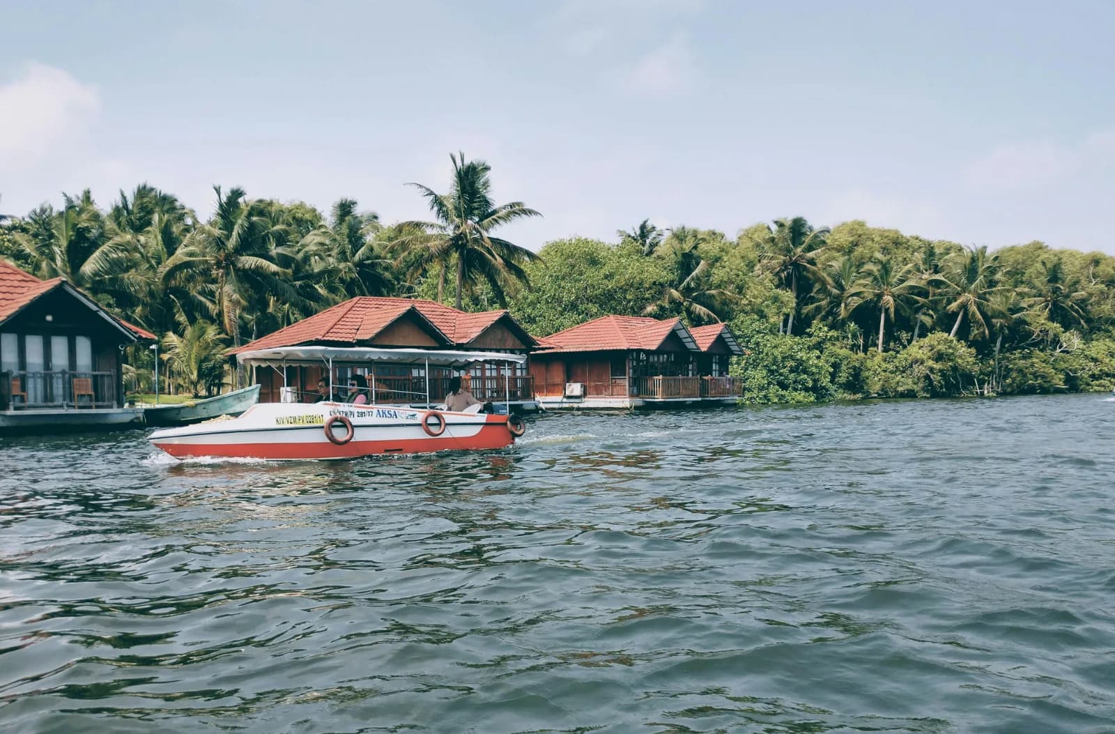 Poovar Island boating experience through the backwaters with boats, mangroves, and scenic estuary views