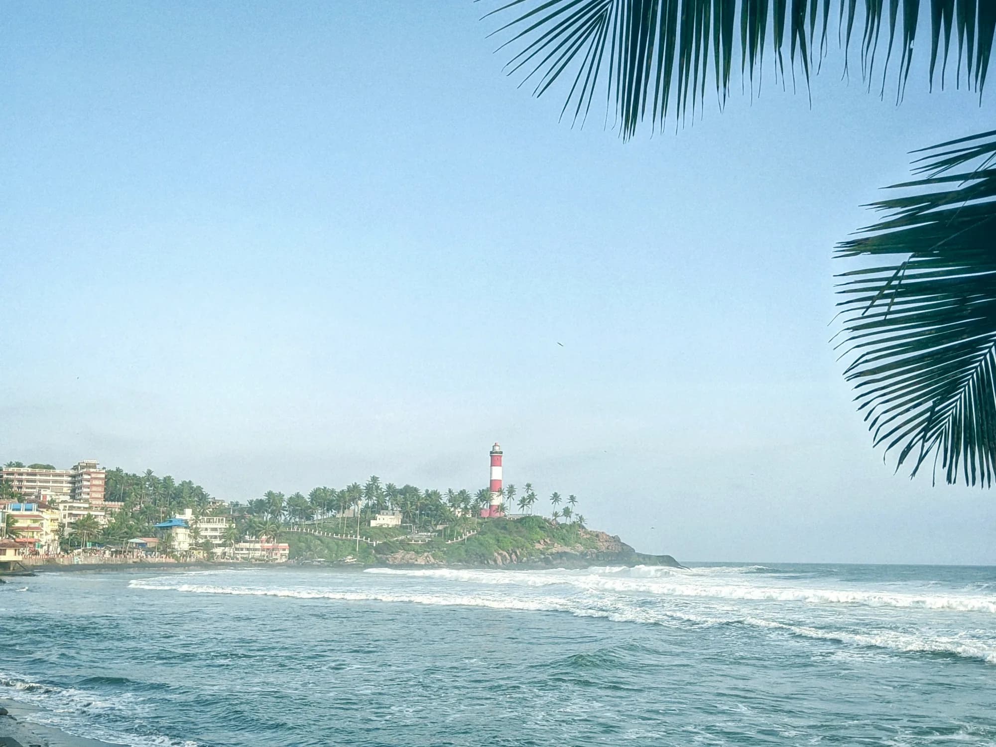 What Kovalam is famous for including Lighthouse Beach, golden sands, Ayurveda tourism, seafood, cultural performances, and coastal attractions in Kerala