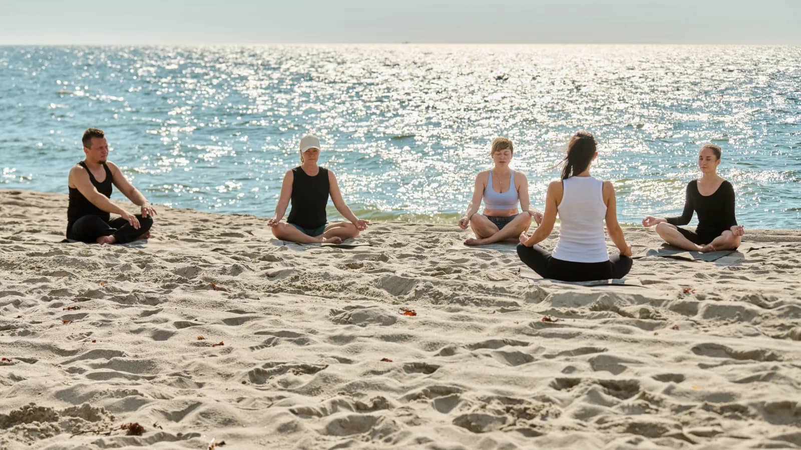 Sunrise yoga session on Kovalam Beach with peaceful Arabian Sea views and traditional wellness atmosphere