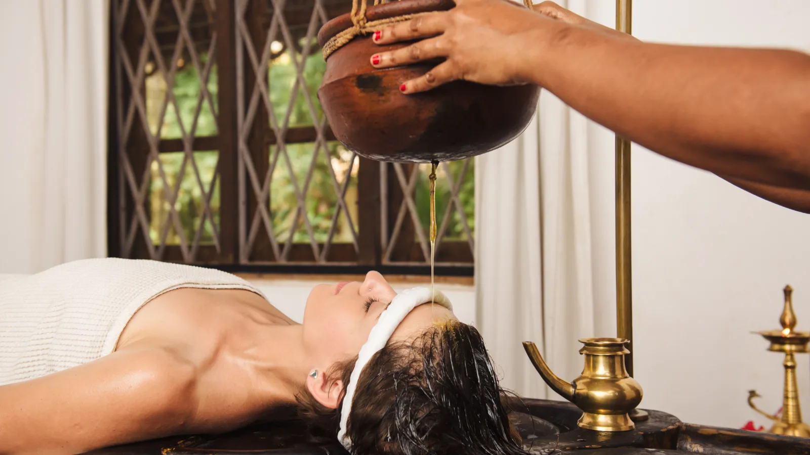 Traditional Kovalam Kerala Ayurveda therapy and wellness treatment experience with herbal oils, massage techniques, and holistic healing practices