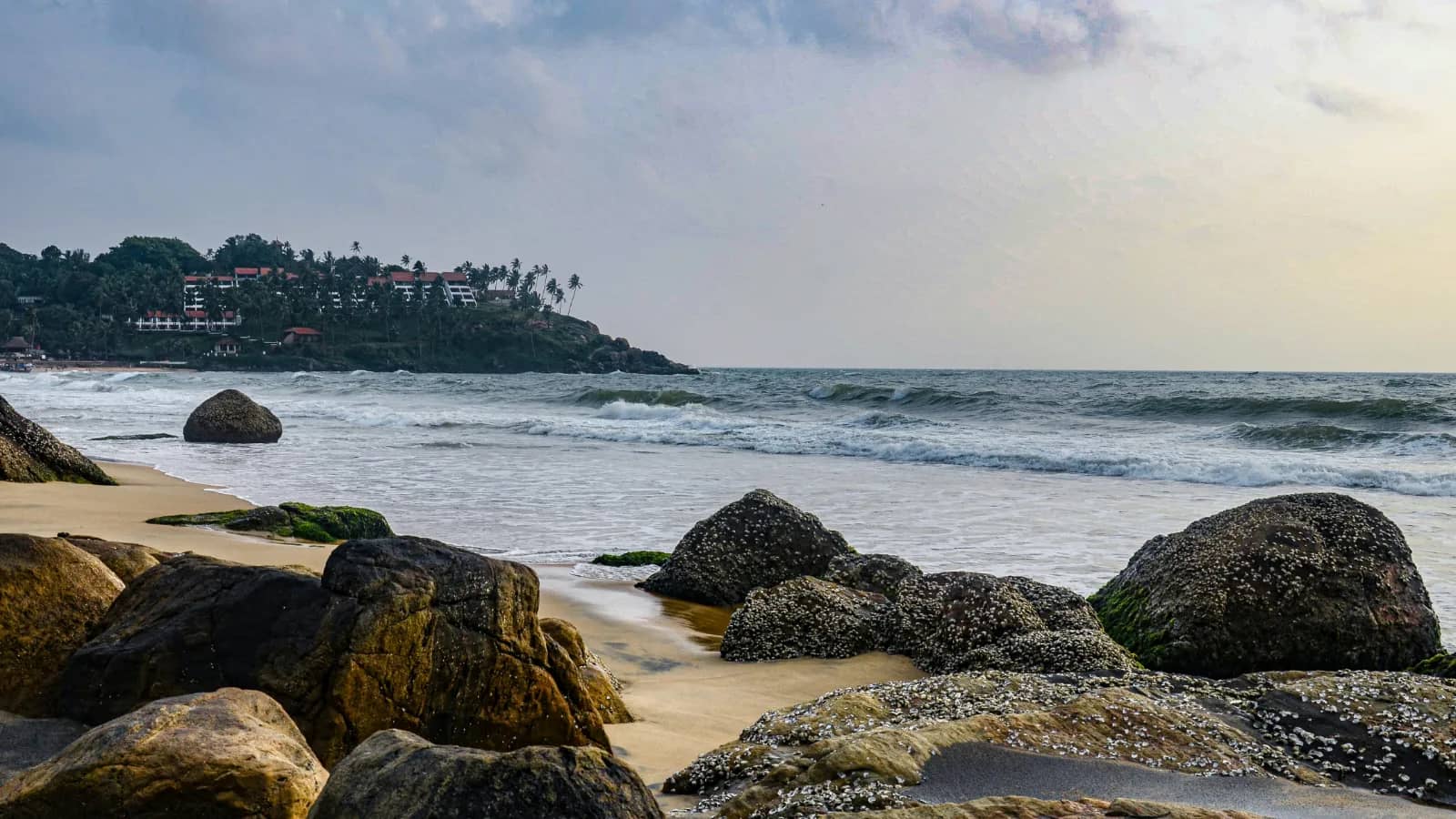 Scenic beach walk in Kovalam with sunset photography views along the Arabian Sea coastline during golden hour